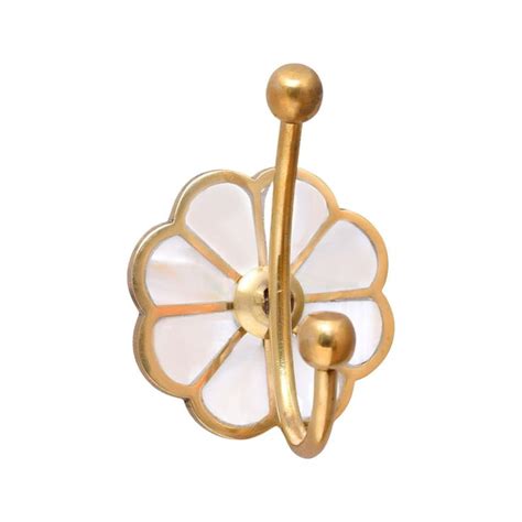 A Gold And White Flower Shaped Hook