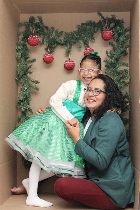 Mom With Her 5 Year Old Brunette Daughter With Eyeglasses Inside A Decorated Gift Box To