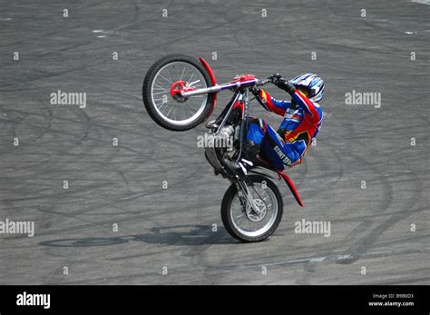 A motorcycle stuntman performing a wheelie Stock Photo - Alamy