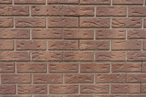 Brown Brick Veneer Wall With Grey Mortar Joints Front View Stock Photo