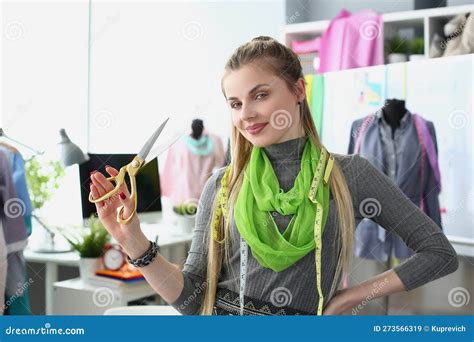 Portrait Of A Smiling Successful Fashion Designer Or Tailor Holding