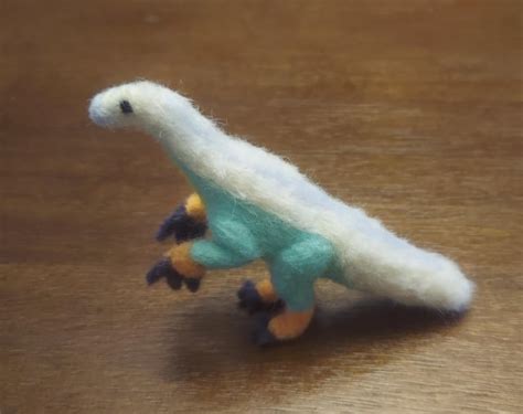 I made a scruffy needle felted therizinosaurus! Colors are loosely ...