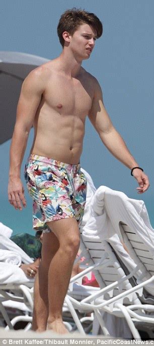 Shirtless Patrick Schwarzenegger Gets Cradled By Bikini Clad Brunette