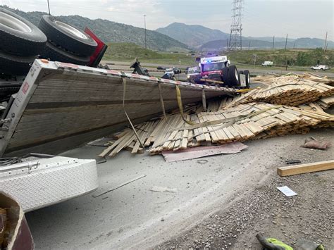 Photos Semi Truck Rollover Spills Lumber Traps Driver On Ramp In