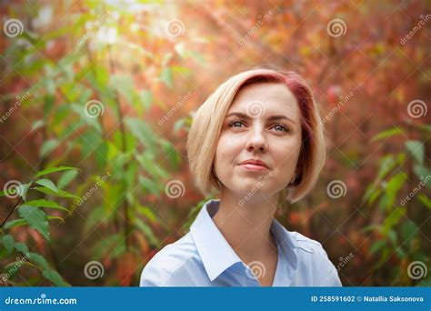 Portrait Of A Pensive Beautiful Middle Aged Blonde Woman In An Autumn Park Stock Photo Image