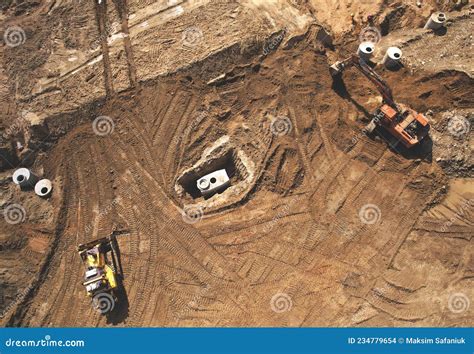 Laying A Concrete Well Ring And Sewer Pipe At Construction Site