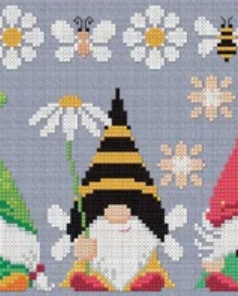 Three Gnomes With Hats And Flowers Are Depicted In This Cross Stitch