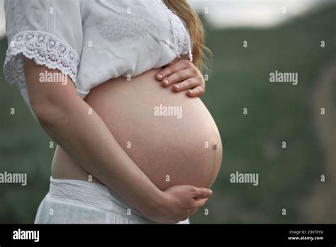 Pregnant Blonde Girl In White In A Green Field Rural Natural Landscape Stock Photo Alamy