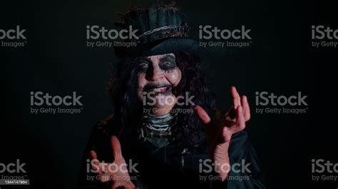 Sinister Senior Mature Woman In Carnival Costume Of Halloween Witch