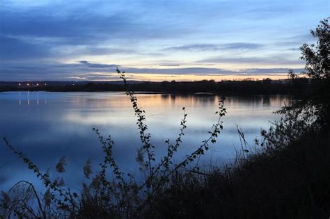 Premium Photo | A beautiful sunset over the lake at the park