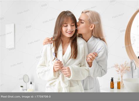 Happy Lesbian Couple Brushing Teeth In Bathroom Stock Photography Agency Pixel Shot Studio