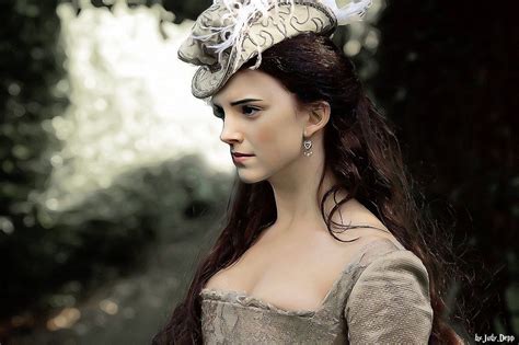 A Woman With Long Brown Hair Wearing A White Dress And Feathered Headdress