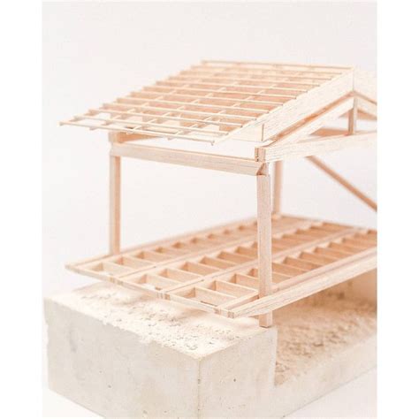 A Model Of A House Made Out Of Wooden Slats And Concrete Blocks On A