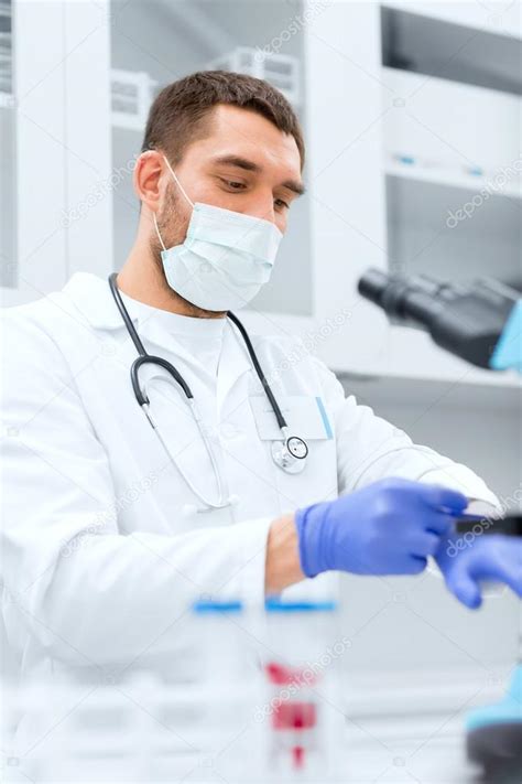 Young male scientist wearing gloves in lab — Stock Photo © Syda ...