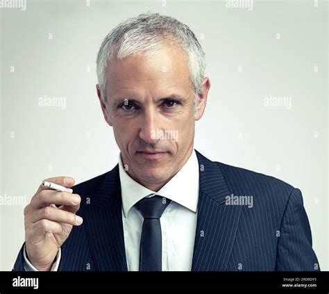 Smoking Suits Him A Cropped Portrait Of A Serious Mature Man In A