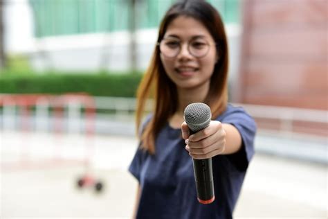 Premium Photo | Portrait of female journalist with microphone standing ...