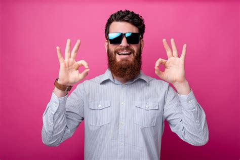 Premium Photo Young Smiling Bearded Man With Sunglasses Showing Ok