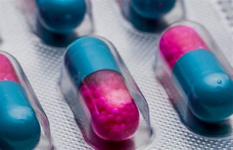 Selective Focus of Blue, Pink Capsule with Granule in Side Pills. Pills in Blister Pack on White ...