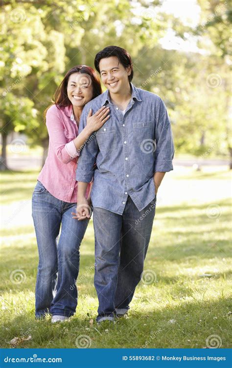 Asian Couple Walking Hand In Hand In Park Stock Photo Image Of