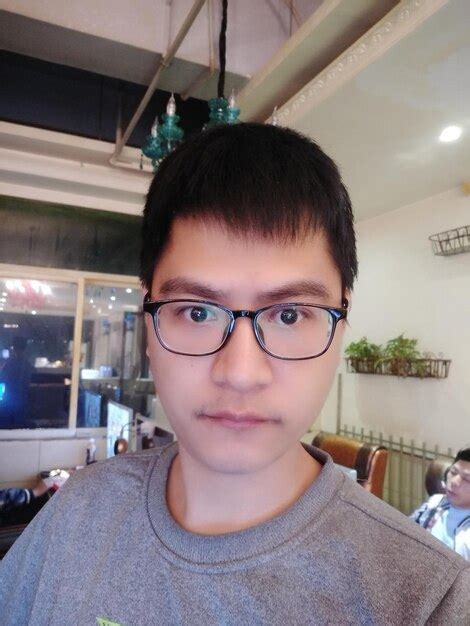 Premium Photo Close Up Portrait Of Man Wearing Eyeglasses At Home