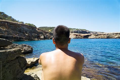 Nude Man Sitting Looking At Mediterranean Sea By Stocksy Contributor