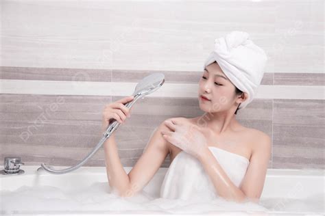 Beautiful Woman Taking A Bath In The Bathtub During The Day Background