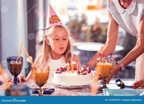 Birthday Girl Making Her With And Blowing Candles On The Cake Stock