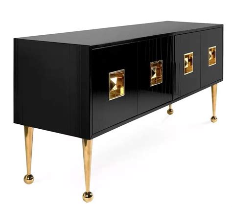 A Black And Gold Sideboard With Two Doors On The Bottom One Door Open