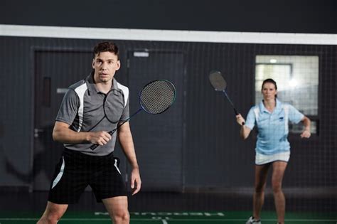 Premium Photo Couple Playing Badminton On Court