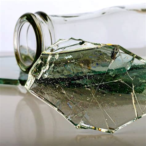 sharp broken glass shards  reflective textures   clear bottle