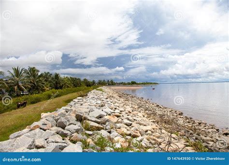 View Of A Dirt Wall Of Boulders Along The Shore Of The Atlantic Ocean