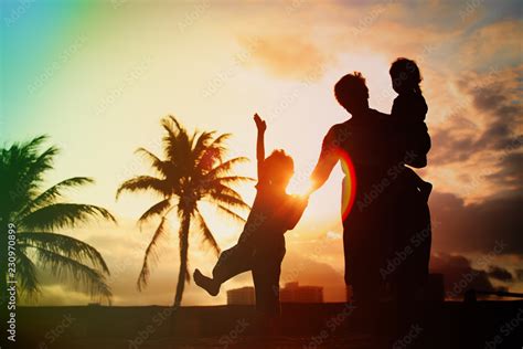 silhouette of family with kids play at sunset beach Stock Photo | Adobe Stock