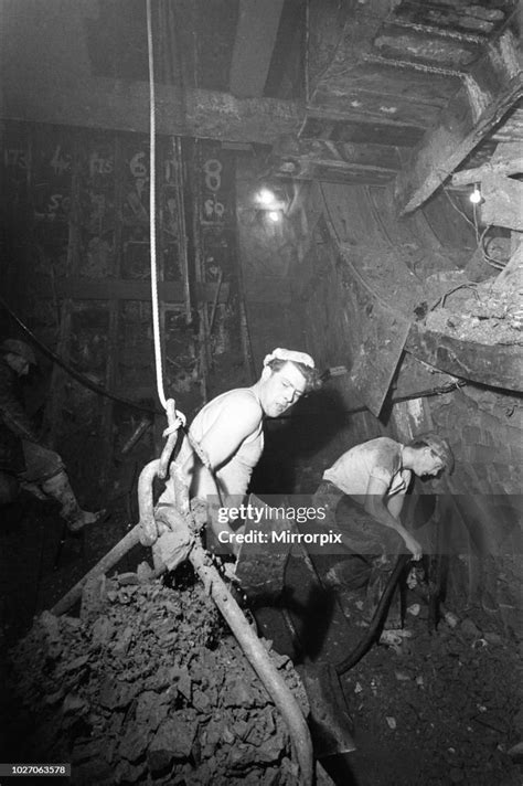 Construction workers digging the new Blackwall Tunnel in muddy and ...