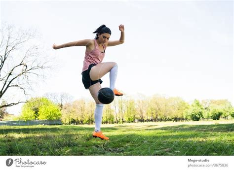 Young female soccer player practicing on field. - a Royalty Free Stock ...