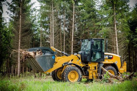 a yellow bulldozer is parked in the woods