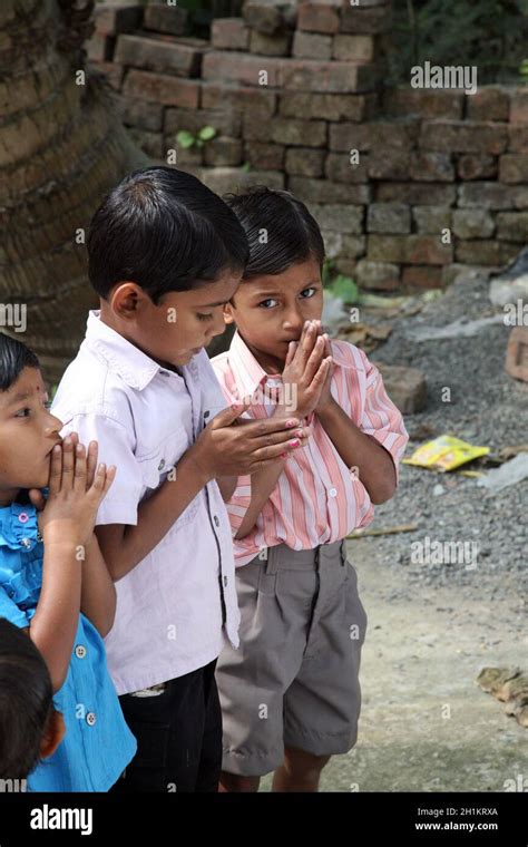 Group Of Young Bengali Catholics Pray Before A Statue Of The Blessed