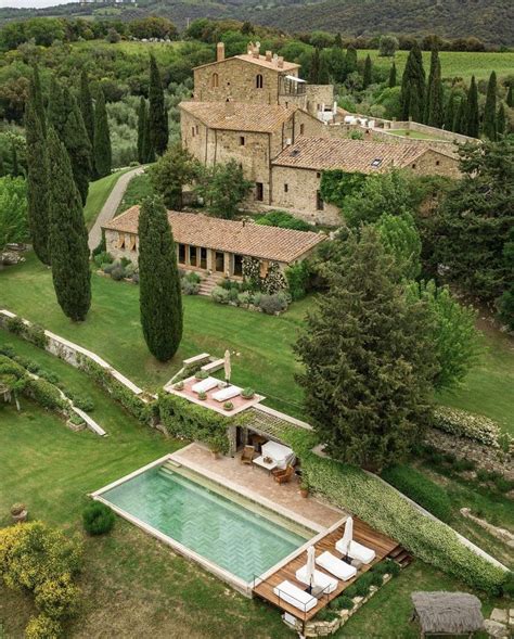 An Aerial View Of A Large House With A Swimming Pool In The Middle Of It