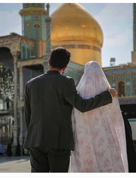 A Man And Woman Standing In Front Of A Building With A Golden Dome On It