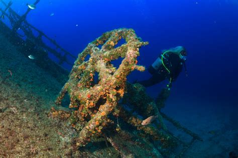 Scuba Diving Exploring And Enjoying Wreck Diving Over A Shipwreck Sea ...