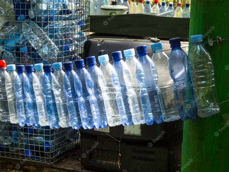 Premium Photo | Empty used plastic bottles on green forest recycling ...