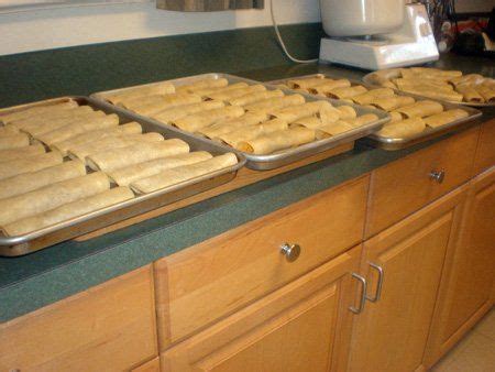 Two Pans Filled With Pastries Sitting On Top Of A Counter Next To A Blender