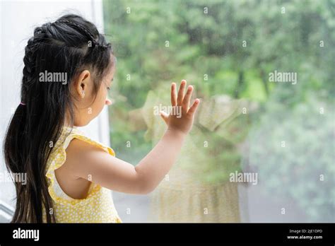Brunette And Preschooler Asian Girl In Yellow Dress Looking Through