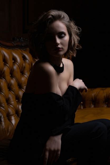 Premium Photo Sensual Brunette Model With Curly Hair And Naked Shoulders Posing With Contrast