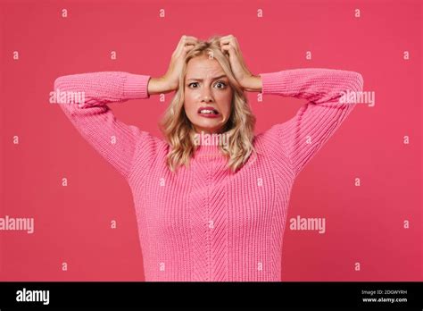 Image Of Confused Blonde Girl Looking At Camera And Grabbing Her Head