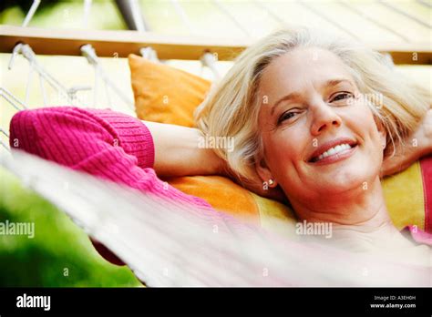 Portrait Of A Mature Woman Lying In A Hammock And Smiling Stock Photo Alamy