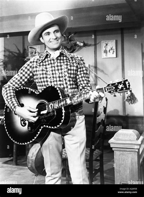 GENE AUTRY US Country singer and actor with his Gibson guitar Stock