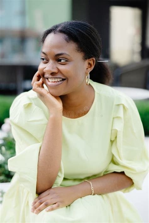 Dark Skinned Lady Laughs Outside Brunette Woman In Yellow Dress Smiles