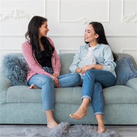 Free Photo Girlfriends Talking While Sitting On Sofa