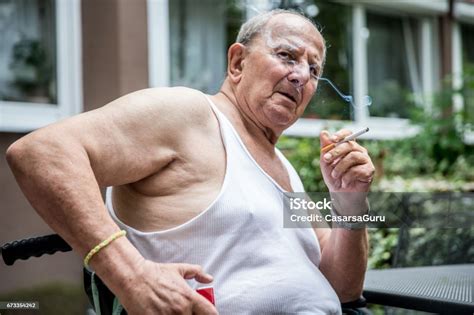 Overweight Senior Man Smoking Cigarette Stock Photo Download Image