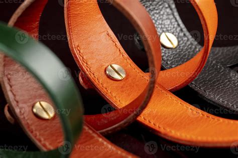 A Group Of Multi Colored Leather Belts On A Black Background 20496988